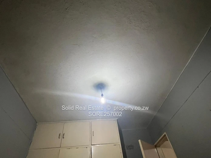 Harare CBD 1BR Ground-Floor Flat — Brick Facade & Cupboards