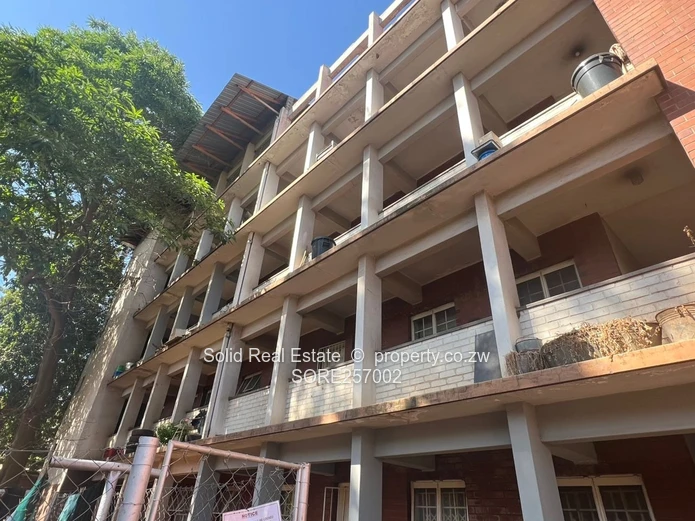 Harare CBD 1BR Ground-Floor Flat — Brick Facade & Cupboards