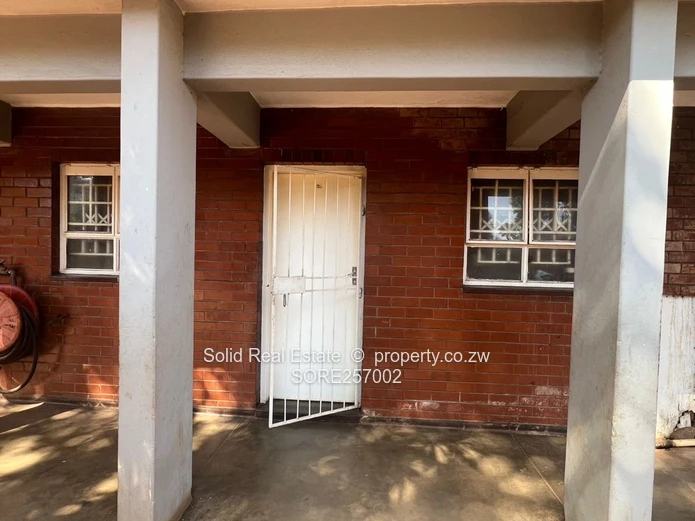 Harare CBD 1BR Ground-Floor Flat — Brick Facade & Cupboards