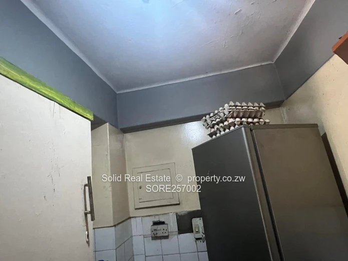 Harare CBD 1BR Ground-Floor Flat — Brick Facade & Cupboards
